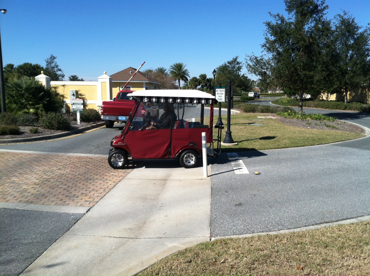 A golf cart travels on the multi modal path that intersects with Hillsborough Trail